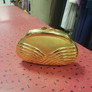 Gold hard shell clutch.